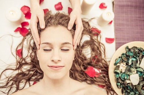 head massage. young woman making massage in the spa. concept about beauty, spa, and massages